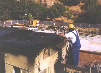 Bob Bennett puts the finishing touches on the roof